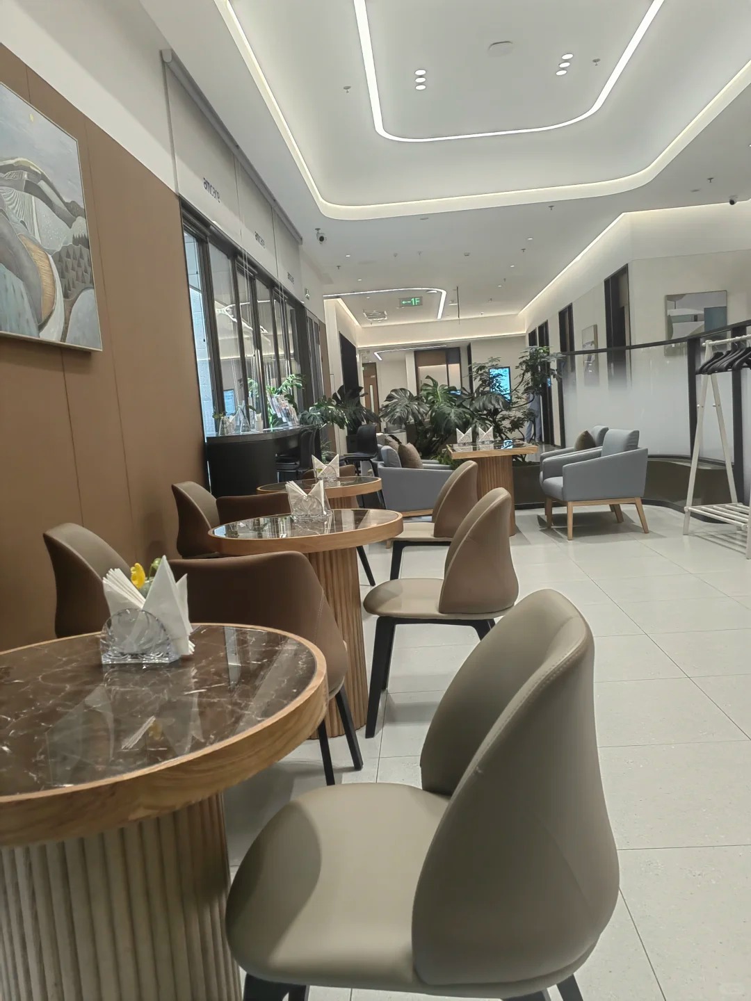 Cafe dining area with marble tables and comfortable chairs