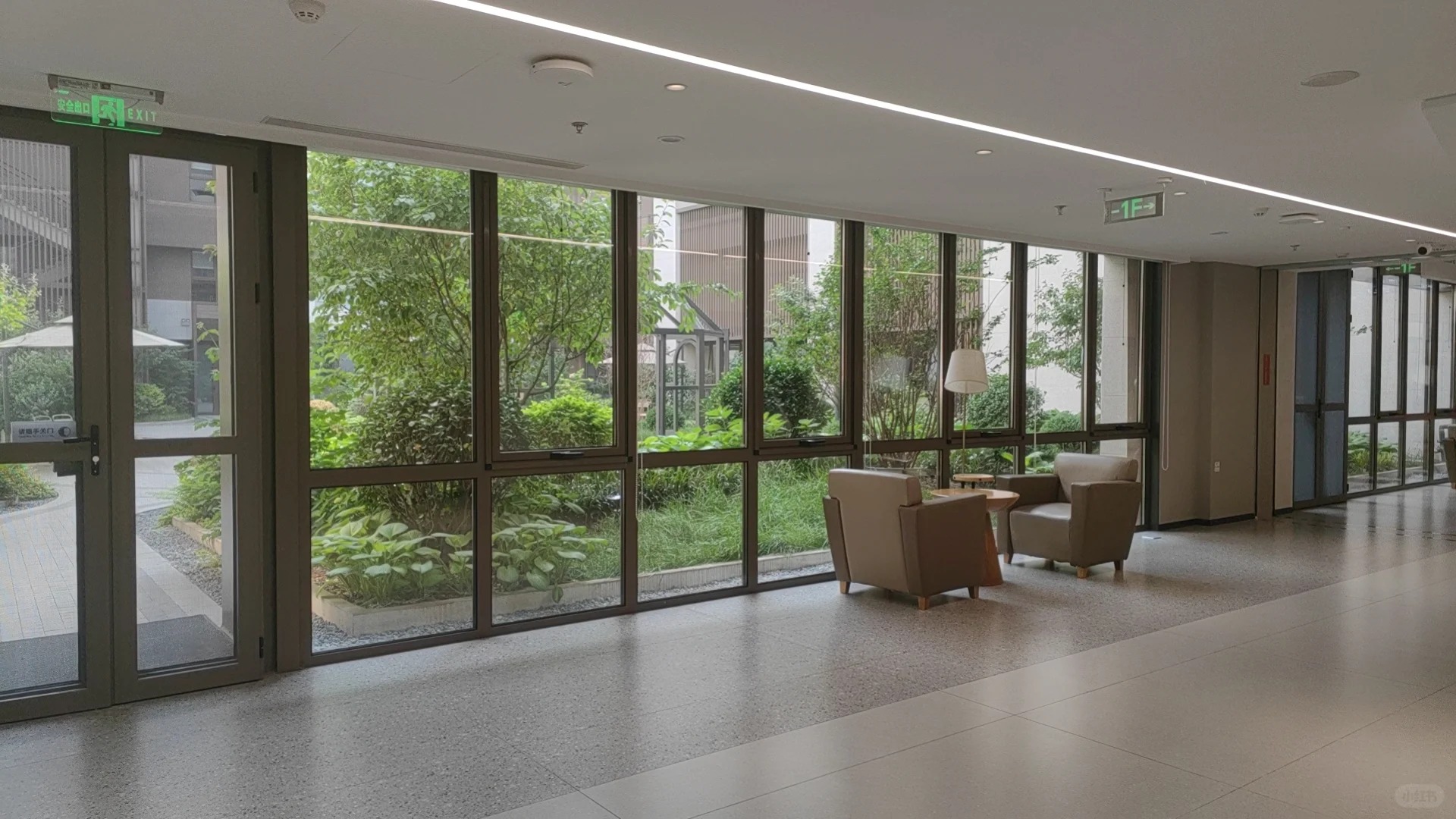Indoor lounge area overlooking green garden courtyard